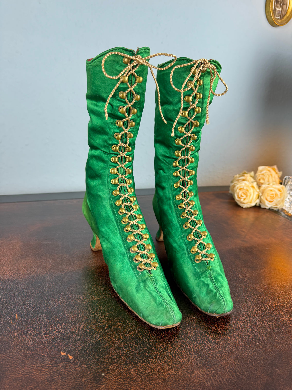 Victorian green silk lace‑up boots, c.1875, with brass fasteners, red leather lining and vivid aniline‑dyed colour
