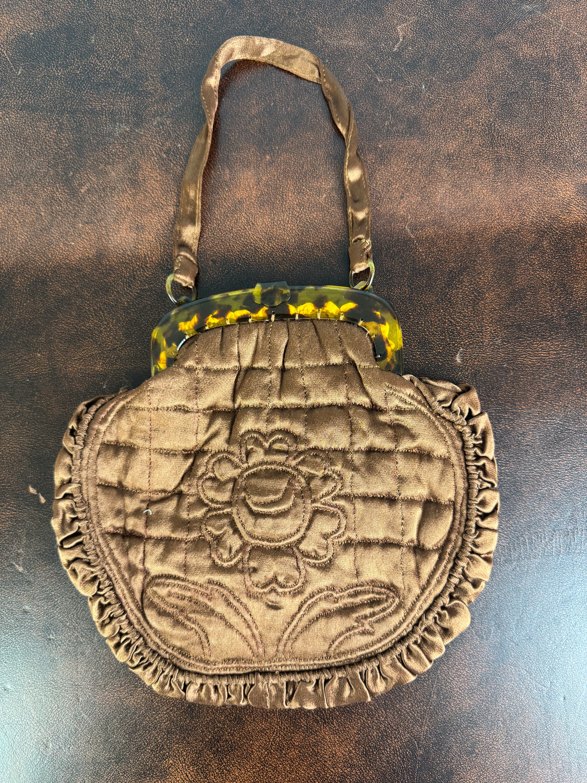Antique brown quilted silk handbag with floral motif and faux tortoiseshell clasp