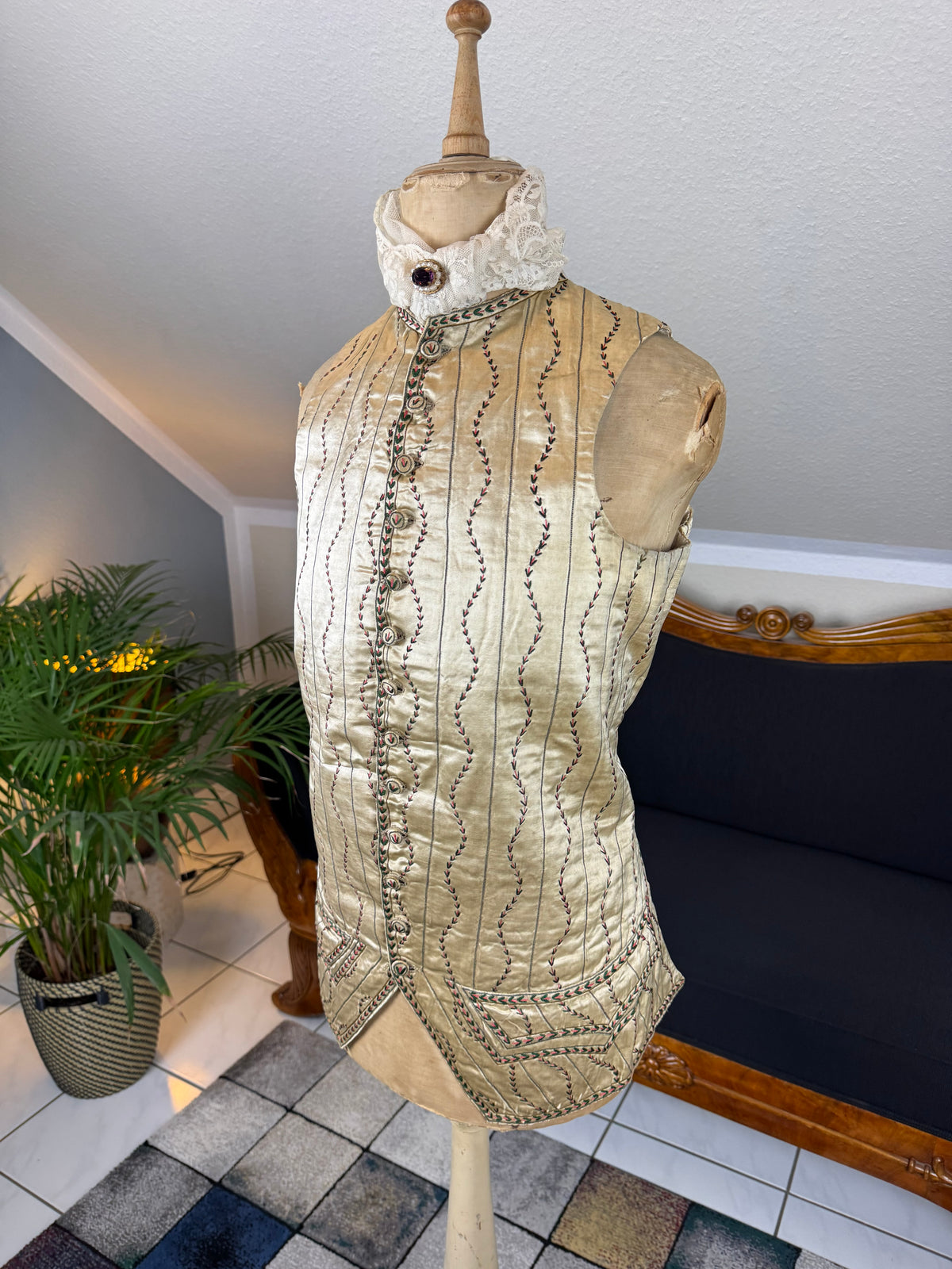 Cream silk embroidered Georgian waistcoat c.1770 from England with long‑line silhouette and floral detailing.
