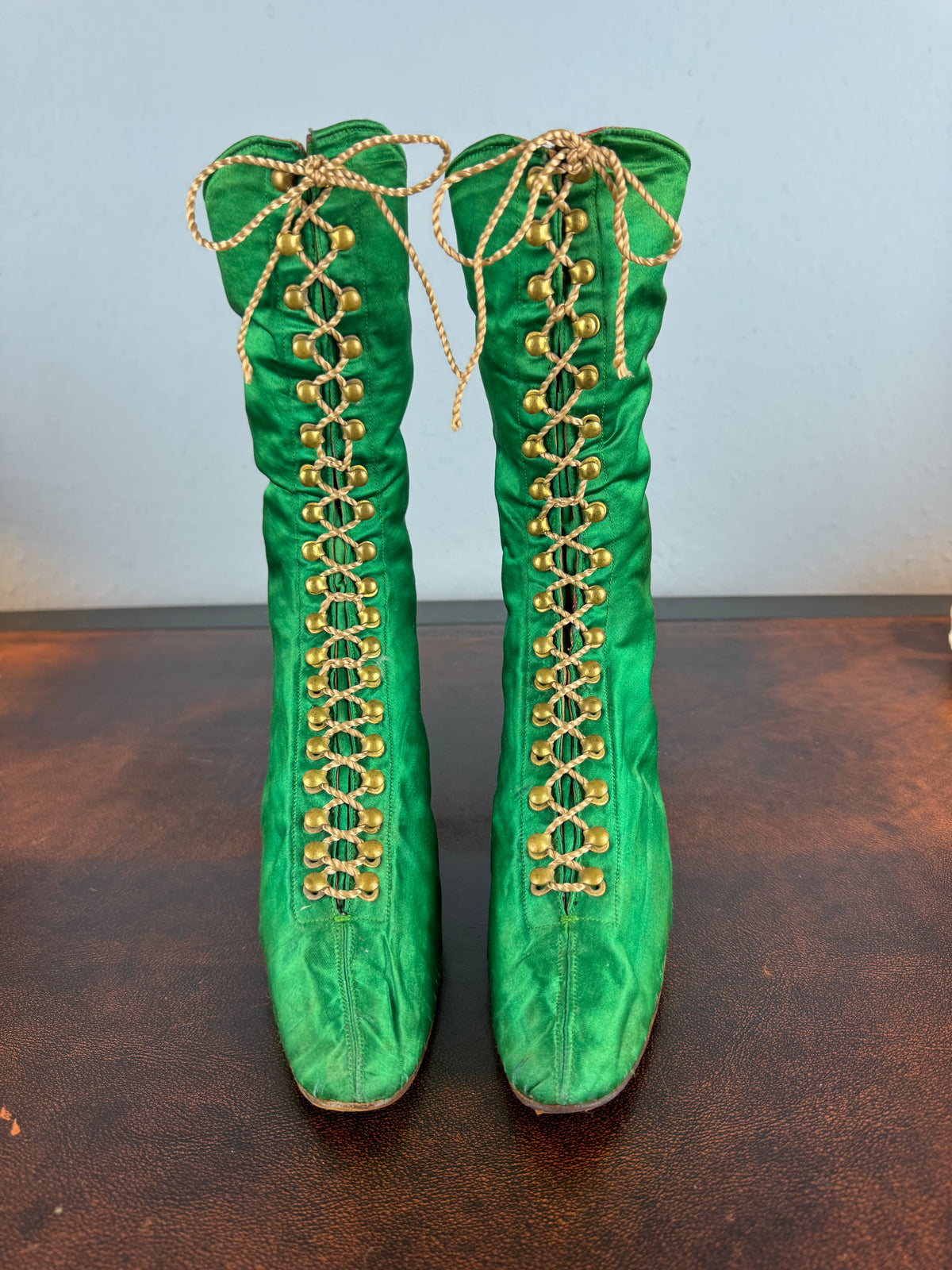 Victorian green silk lace‑up boots, c.1875, with brass fasteners, red leather lining and vivid aniline‑dyed colour