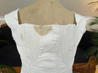 Antique corded cotton corset ca. 1825–1830 with shaped bust, bone eyelets and handwritten owner’s name, early 19th‑century Regency corsetry