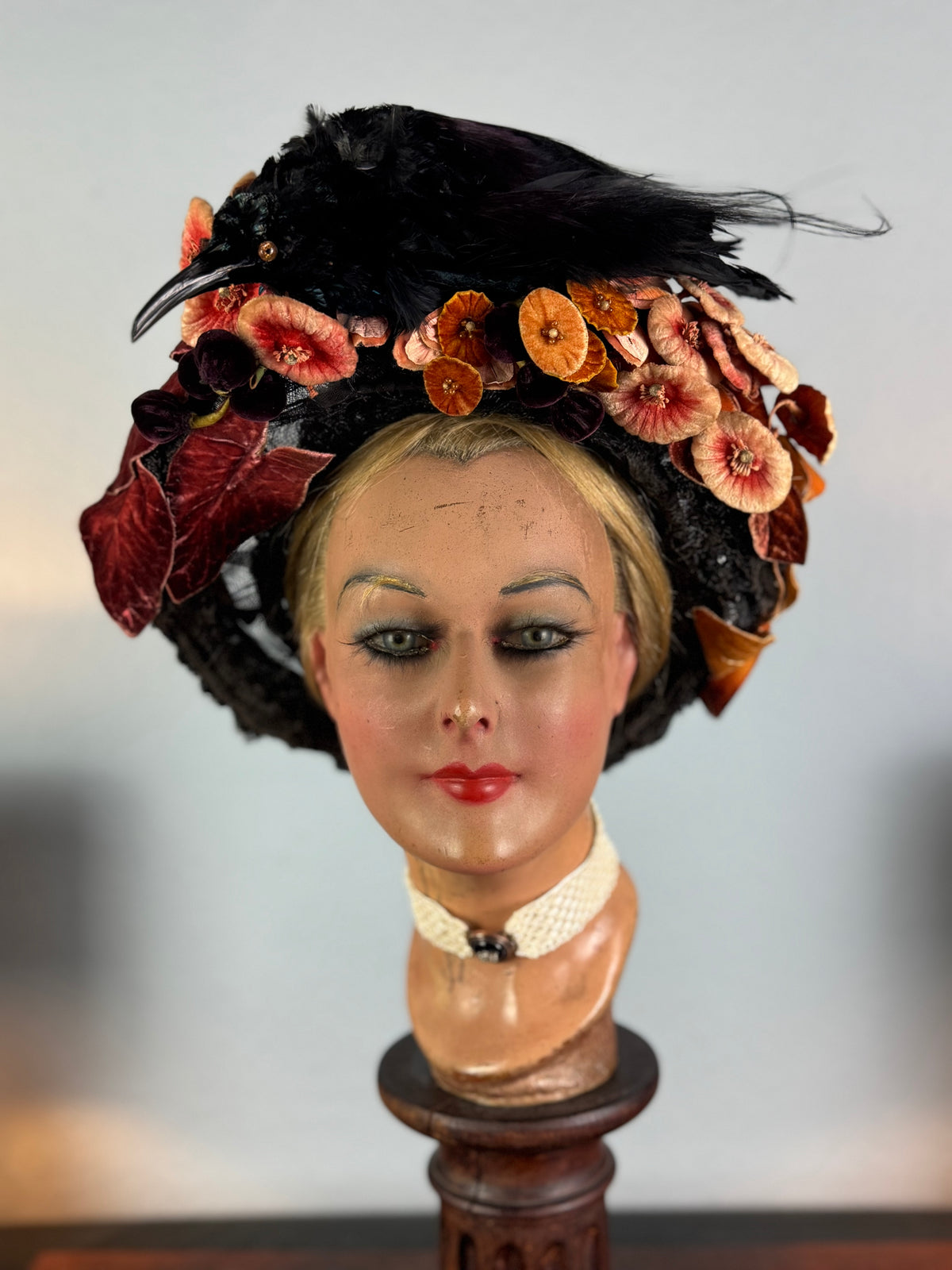 Autumn antique hat with exotic bird decoration, black lace and foliage, early 20th century