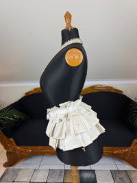 Victorian white linen four‑tier bustle pad c.1898 with pleated tiers and cotton waist tie.