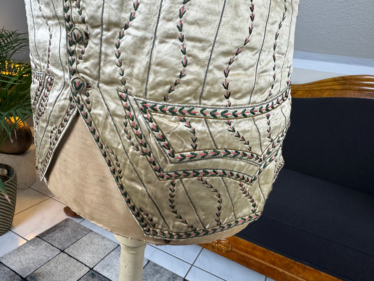 Cream silk embroidered Georgian waistcoat c.1770 from England with long‑line silhouette and floral detailing.