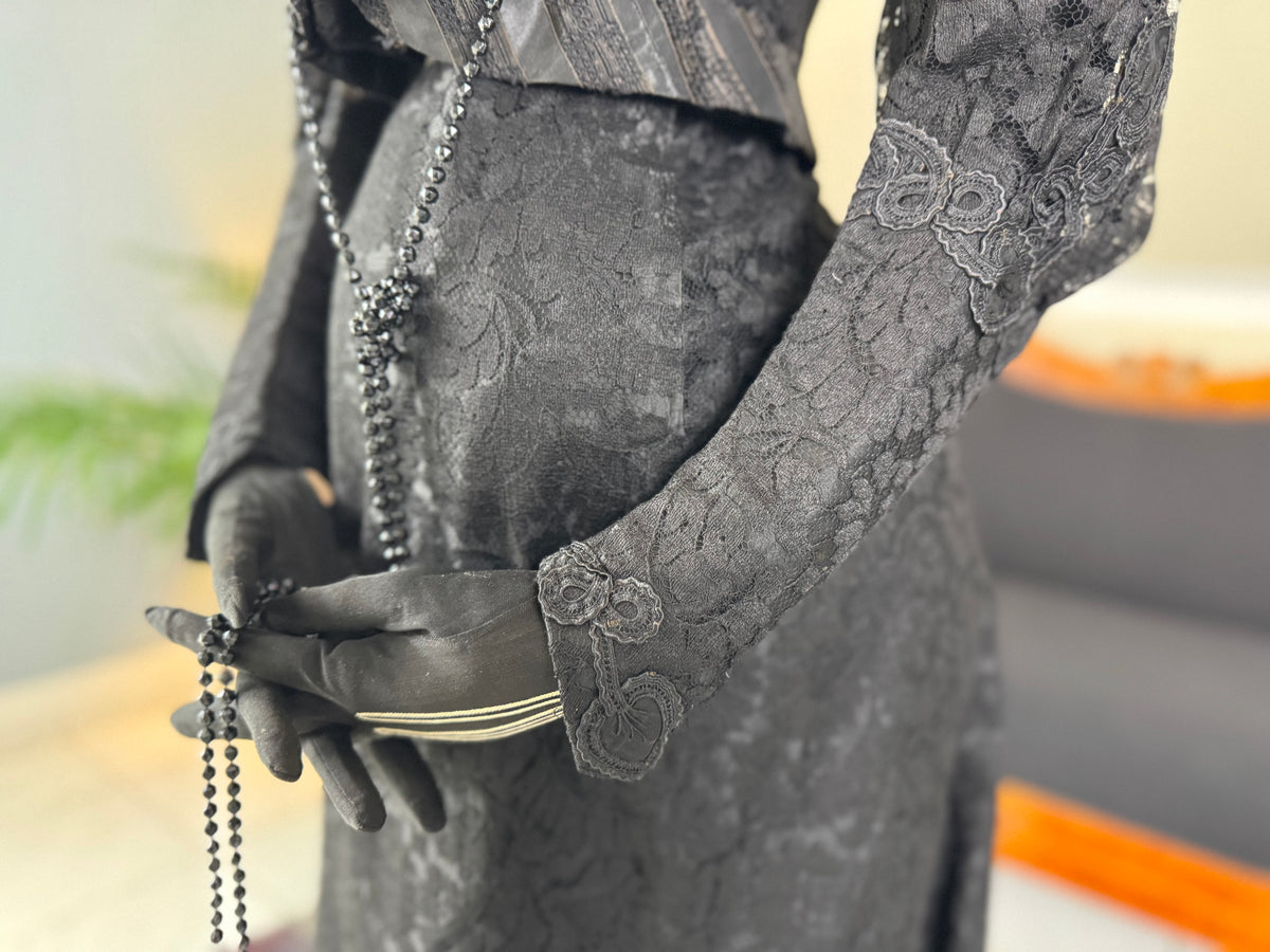 Antique two‑piece dress with pigeon‑breast bodice and silk appliqués