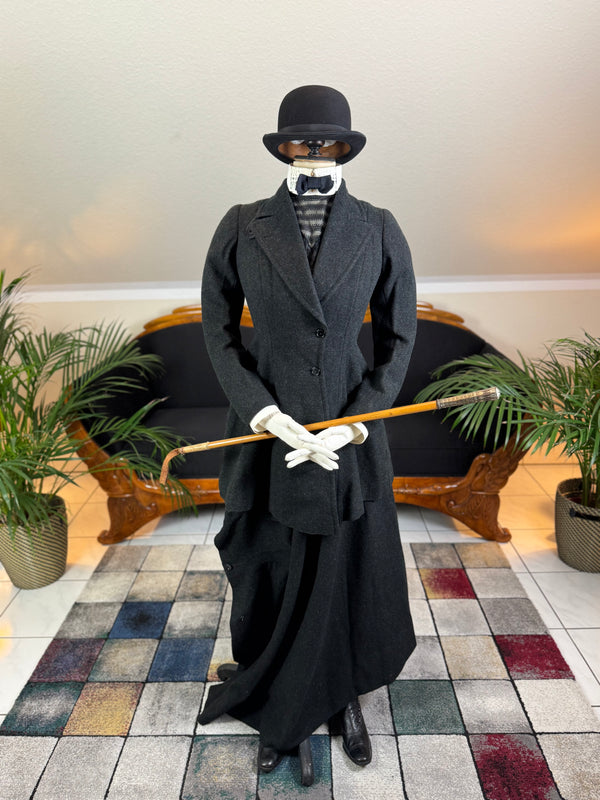Early 20th‑century British riding ensemble with black wool jacket, skirt and antique accessories