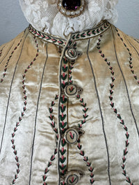 Cream silk embroidered Georgian waistcoat c.1770 from England with long‑line silhouette and floral detailing.