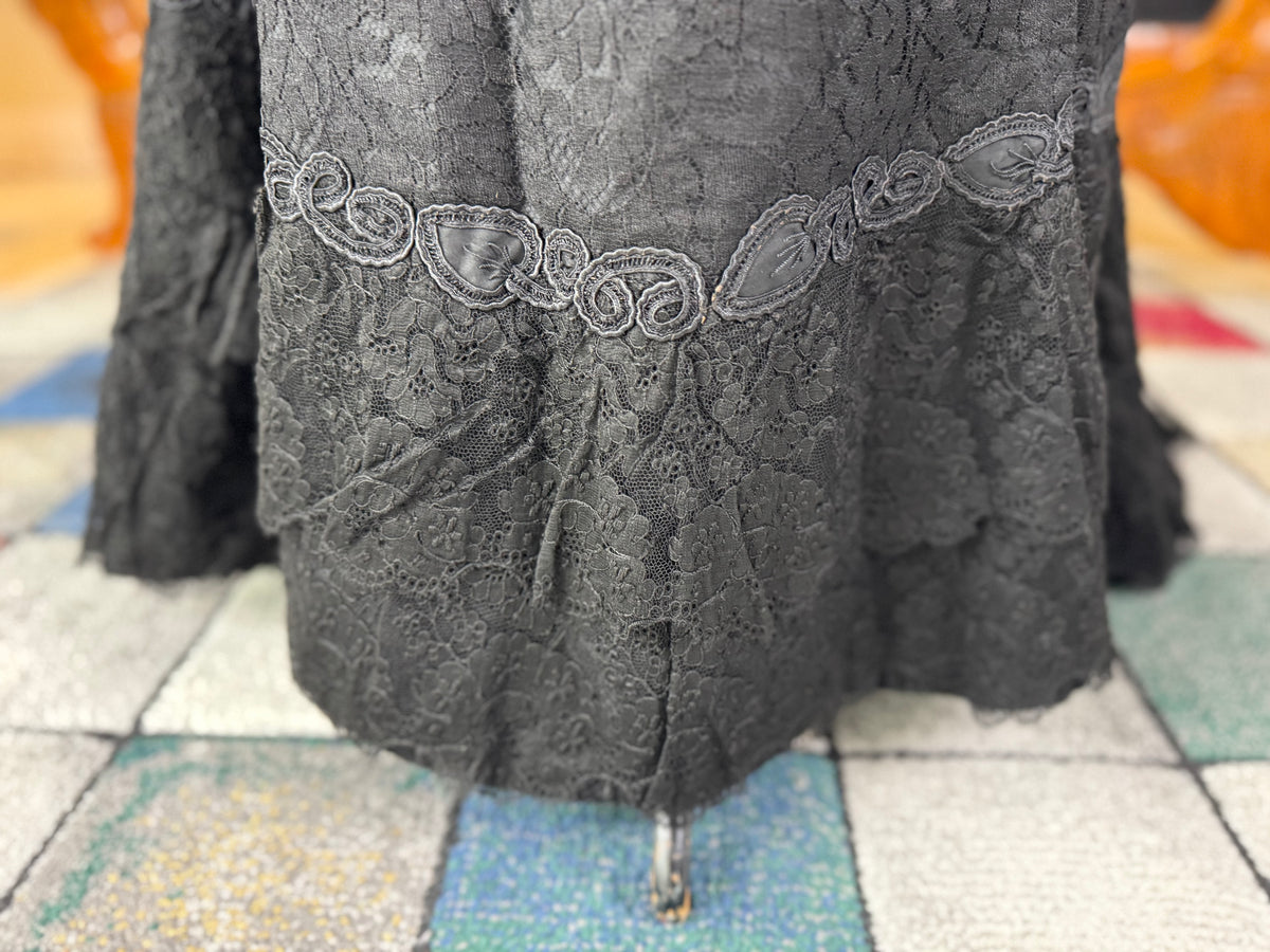 Antique two‑piece dress with pigeon‑breast bodice and silk appliqués