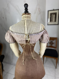 1805 white silk Regency Spencer with short sleeves, high waistline and decorative front closure, antique garment