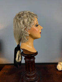 Antique theatrical wig c.1890 made of horsehair with black silk bow from Clarkson’s Wellington Street workshop