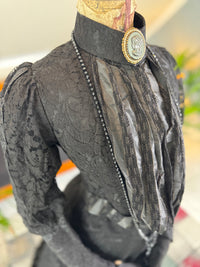 Antique two‑piece dress with pigeon‑breast bodice and silk appliqués