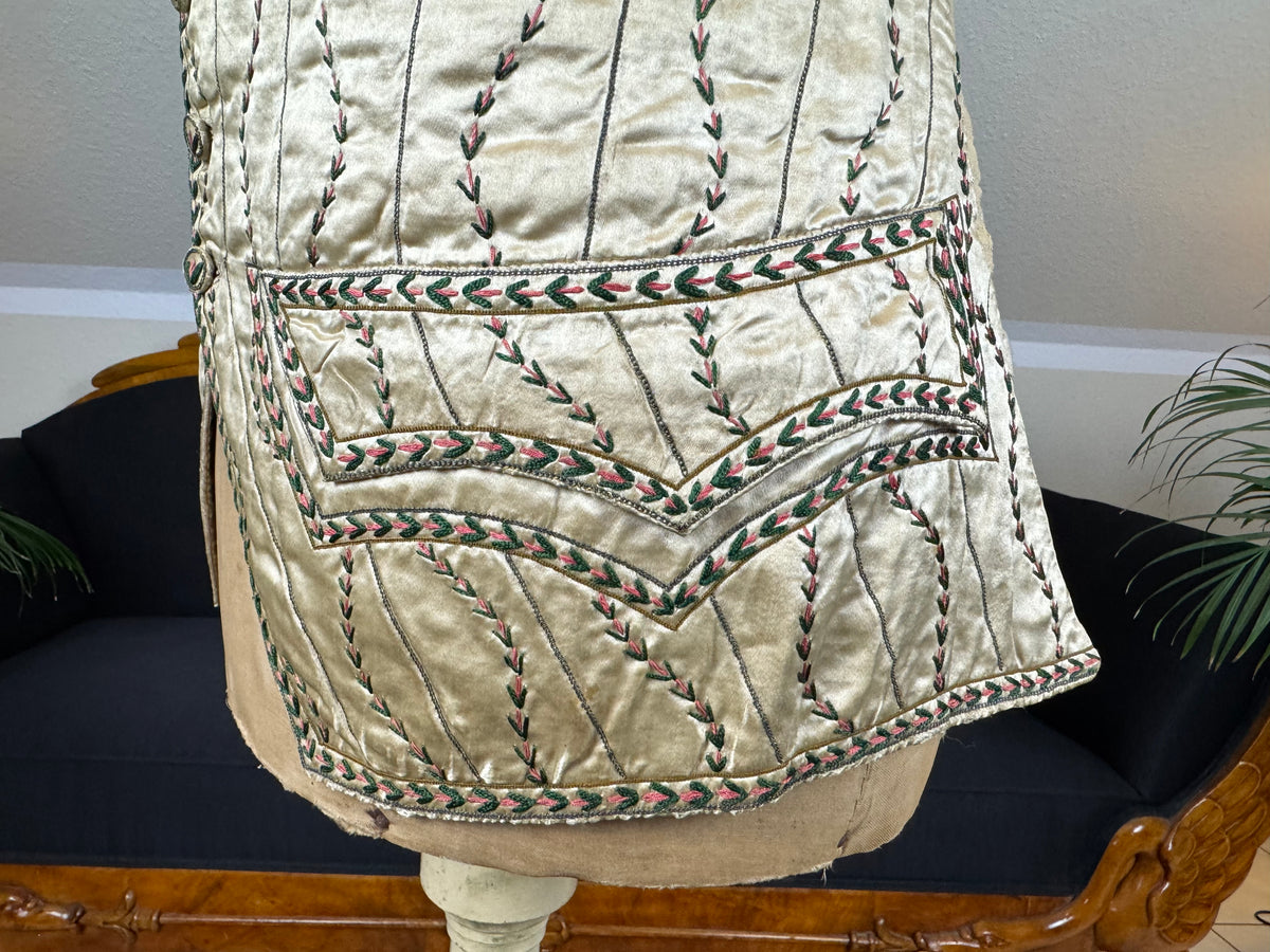 Cream silk embroidered Georgian waistcoat c.1770 from England with long‑line silhouette and floral detailing.