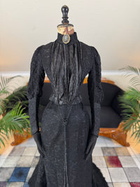 Antique two‑piece dress with pigeon‑breast bodice and silk appliqués