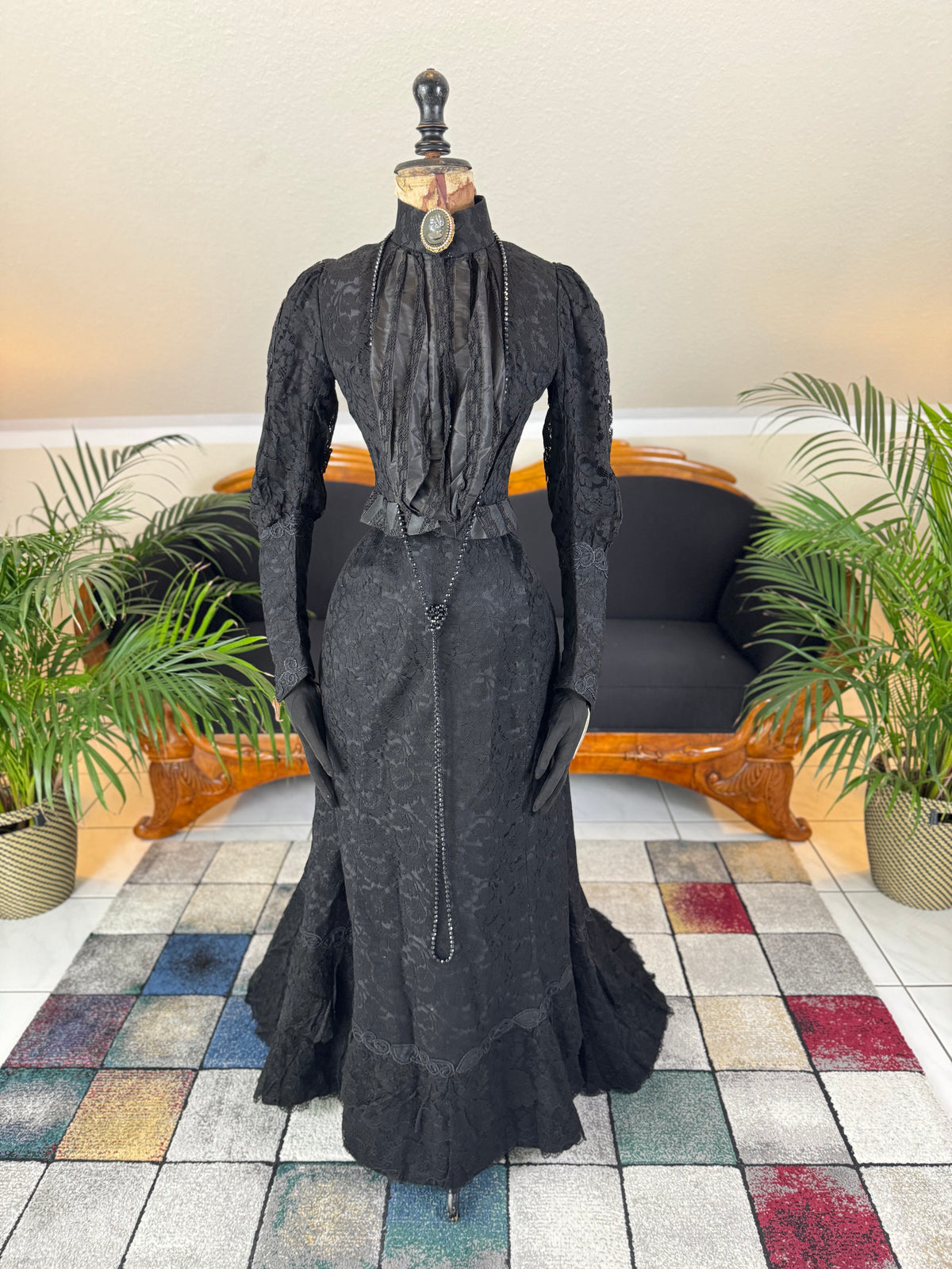 Antique two‑piece dress with pigeon‑breast bodice and silk appliqués