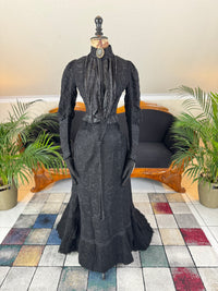 Antique two‑piece dress with pigeon‑breast bodice and silk appliqués