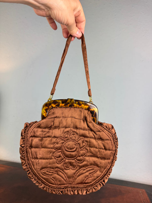 Antique brown quilted silk handbag with floral motif and faux tortoiseshell clasp
