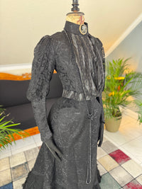 Antique two‑piece dress with pigeon‑breast bodice and silk appliqués