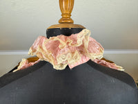 Pink ruffled French bust insert c.1901 with high standing collar and layered Belle Époque frills.