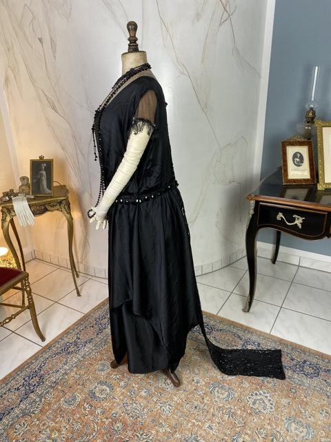 1918 black silk evening dress with sequins, cabochon stones and narrow train, antique transitional gown