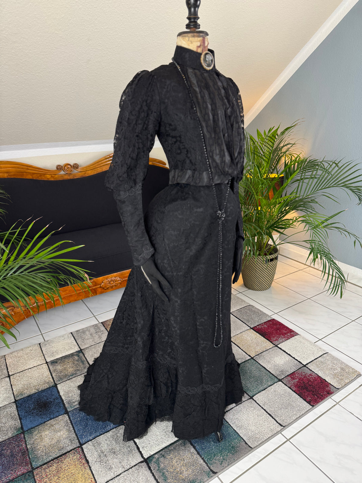 Antique two‑piece dress with pigeon‑breast bodice and silk appliqués