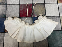 Victorian white linen four‑tier bustle pad c.1898 with pleated tiers and cotton waist tie.