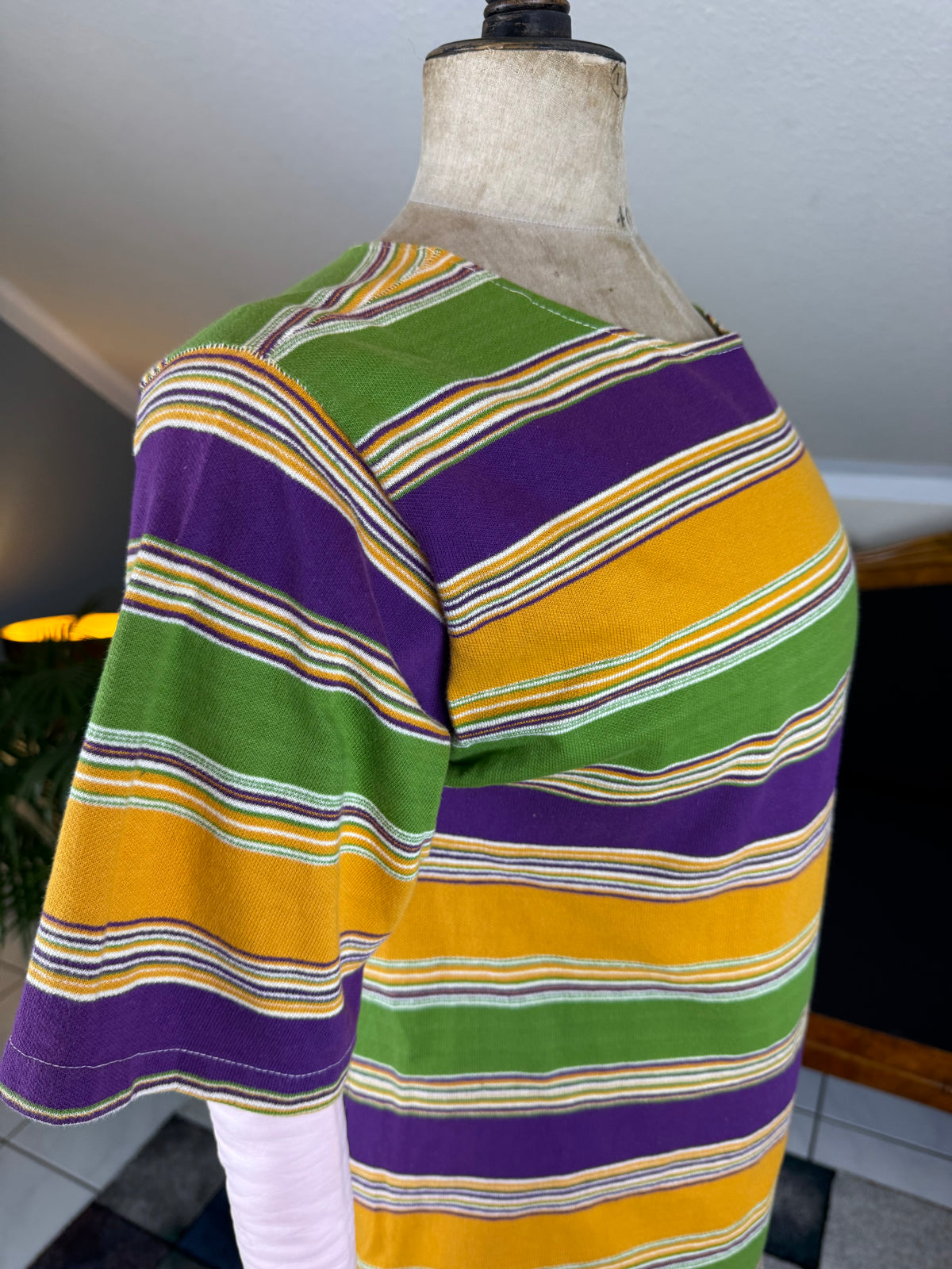 1920s bathing costume with short‑sleeved top and striped shorts