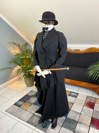 Early 20th‑century British riding ensemble with black wool jacket, skirt and antique accessories