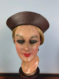 Small French brown straw hat with two back ribbons, sailor‑style shape, well preserved