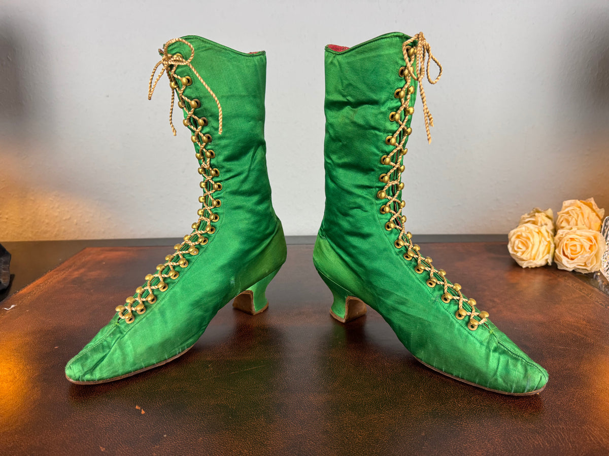 Victorian green silk lace‑up boots, c.1875, with brass fasteners, red leather lining and vivid aniline‑dyed colour