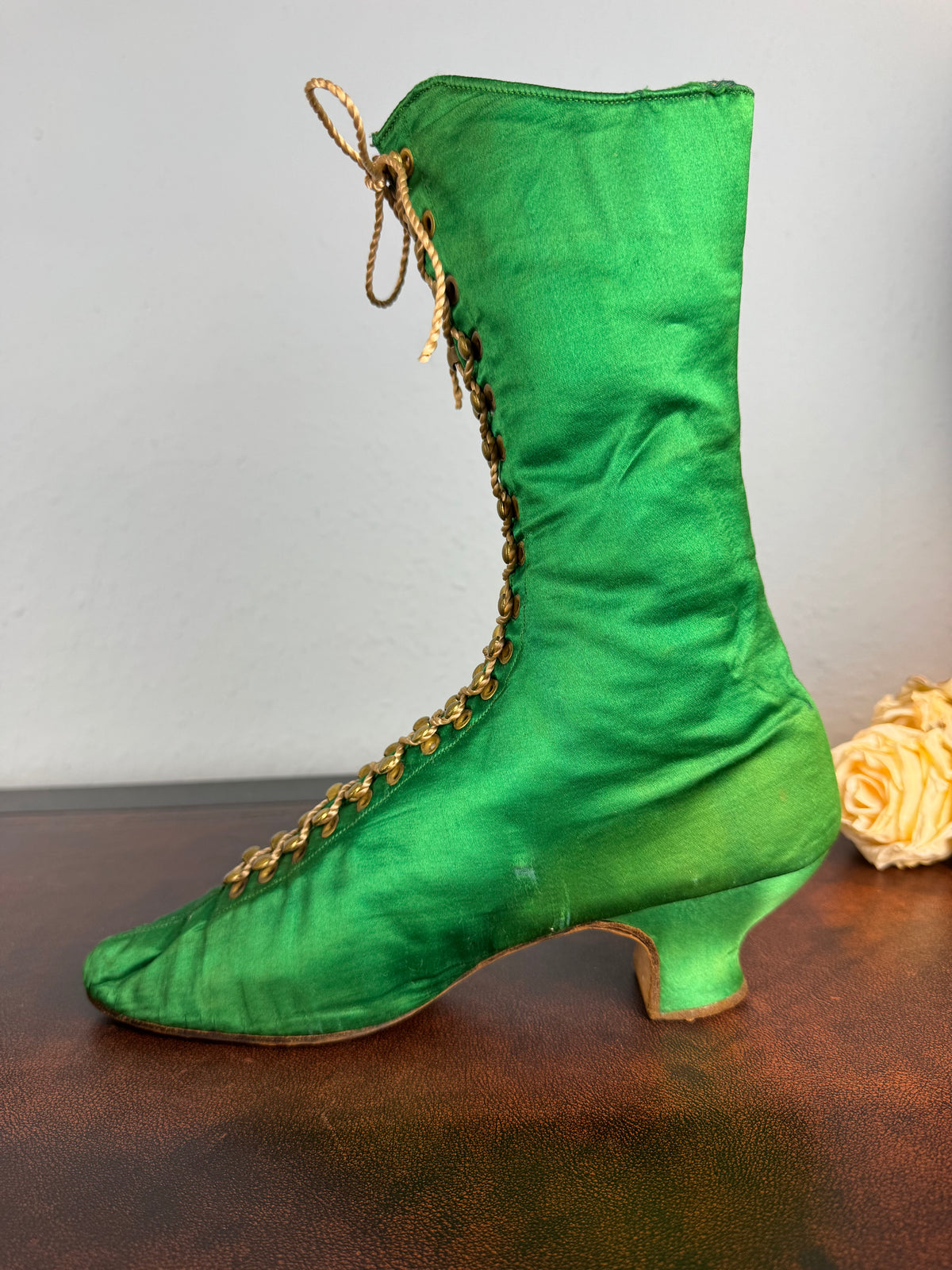 Victorian green silk lace‑up boots, c.1875, with brass fasteners, red leather lining and vivid aniline‑dyed colour