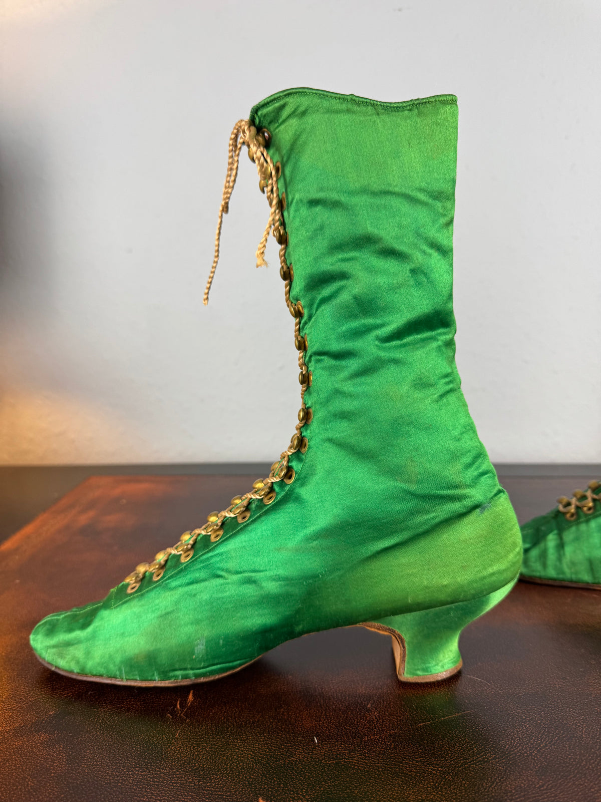 Victorian green silk lace‑up boots, c.1875, with brass fasteners, red leather lining and vivid aniline‑dyed colour