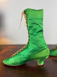 Victorian green silk lace‑up boots, c.1875, with brass fasteners, red leather lining and vivid aniline‑dyed colour
