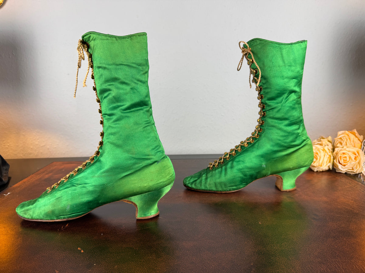 Victorian green silk lace‑up boots, c.1875, with brass fasteners, red leather lining and vivid aniline‑dyed colour