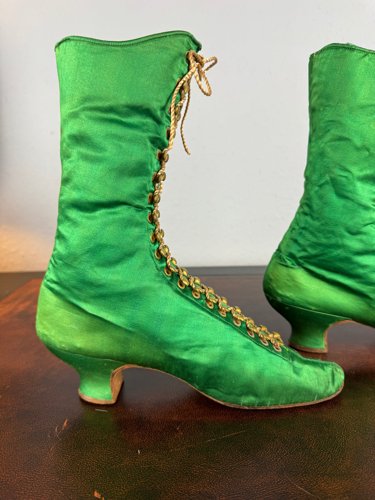 Victorian green silk lace‑up boots, c.1875, with brass fasteners, red leather lining and vivid aniline‑dyed colour
