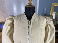 1906 Edwardian wool coat — shoulder area with passe‑partout trim