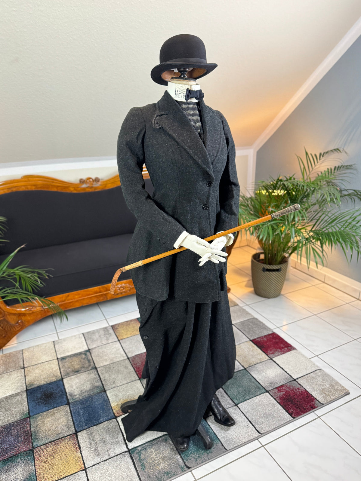 Early 20th‑century British riding ensemble with black wool jacket, skirt and antique accessories