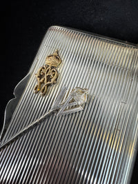 Silver cigarette case of Crown Prince Wilhelm of Prussia with crowned monogram, presentation pin and original caricature in bespoke casket.