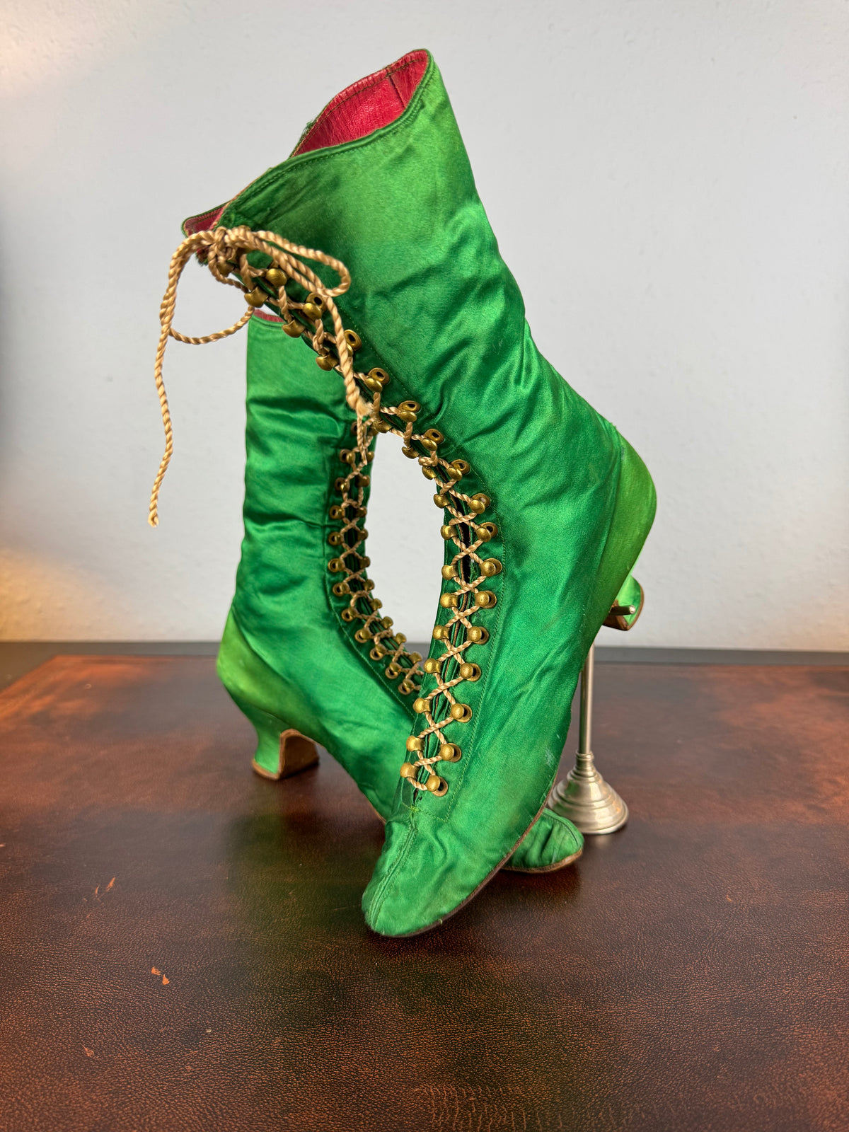 Victorian green silk lace‑up boots, c.1875, with brass fasteners, red leather lining and vivid aniline‑dyed colour