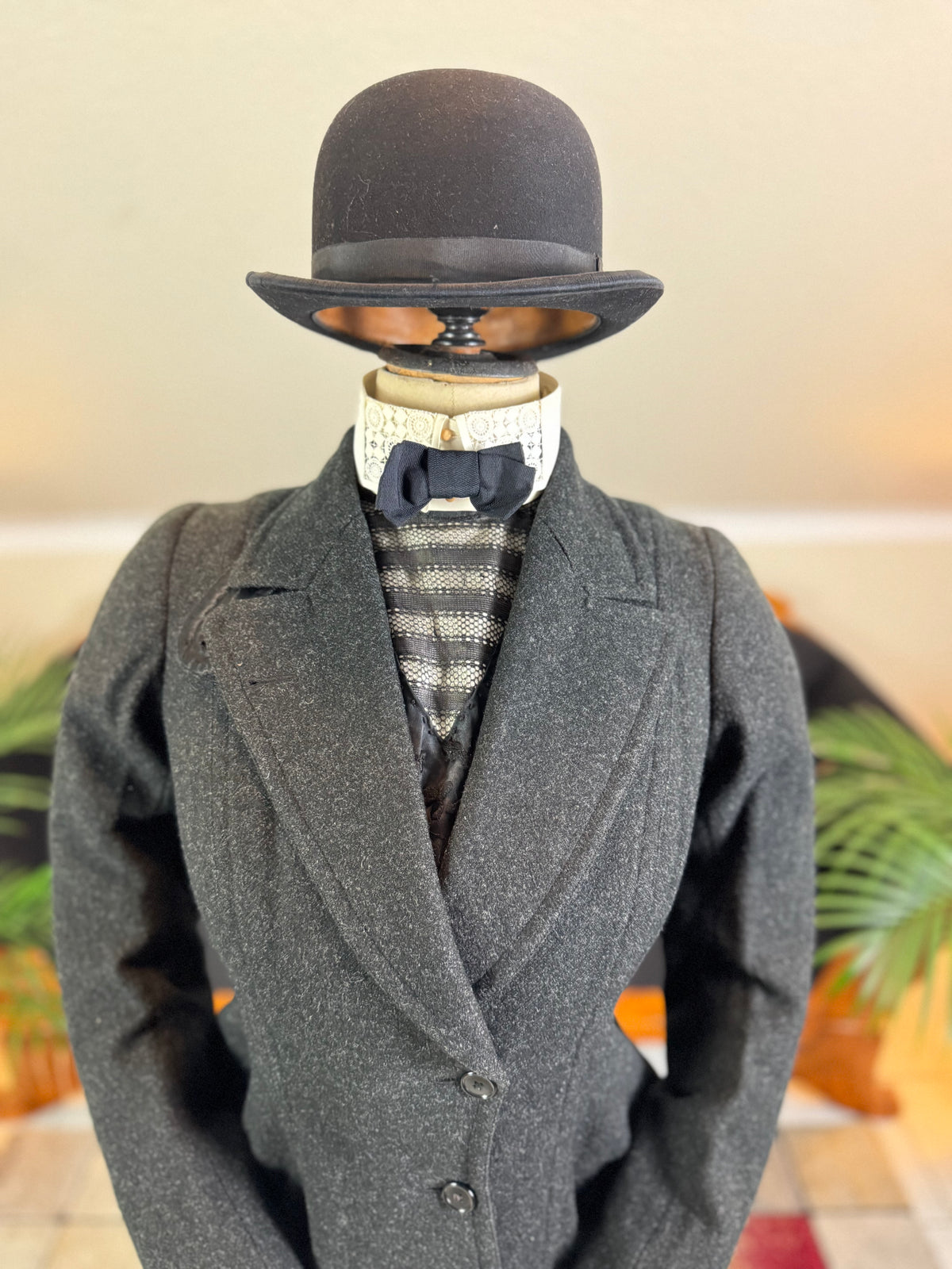 Early 20th‑century British riding ensemble with black wool jacket, skirt and antique accessories