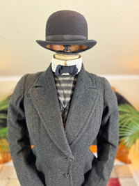 Early 20th‑century British riding ensemble with black wool jacket, skirt and antique accessories