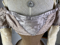 1805 white silk Regency Spencer with short sleeves, high waistline and decorative front closure, antique garment