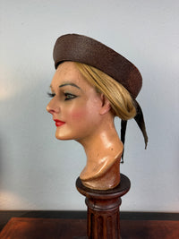 Small French brown straw hat with two back ribbons, sailor‑style shape, well preserved
