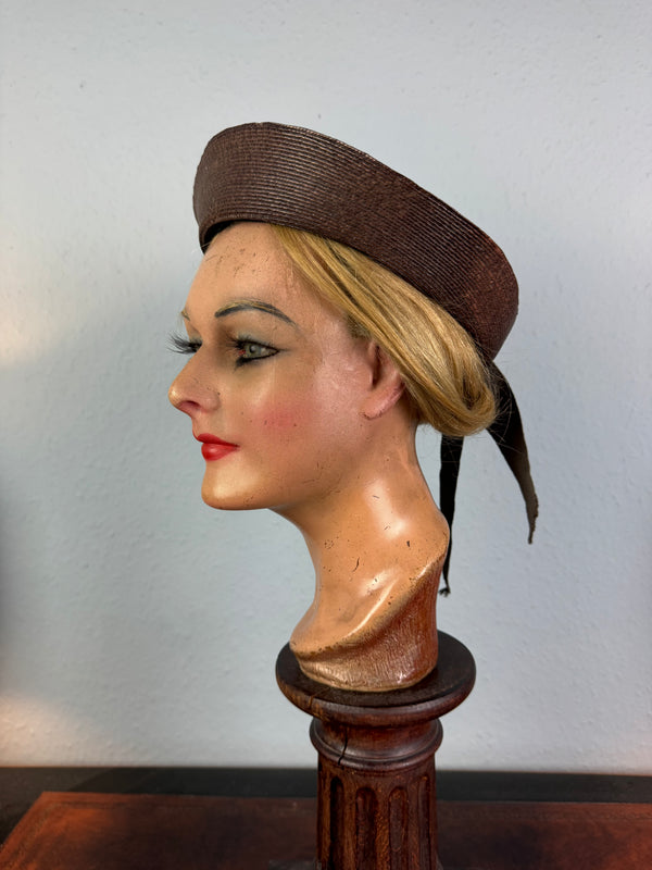 Small French brown straw hat with two back ribbons, sailor‑style shape, well preserved