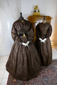1840s Biedermeier mother‑daughter afternoon dresses in printed cotton with wide sleeves and fitted bodices, antique gowns
