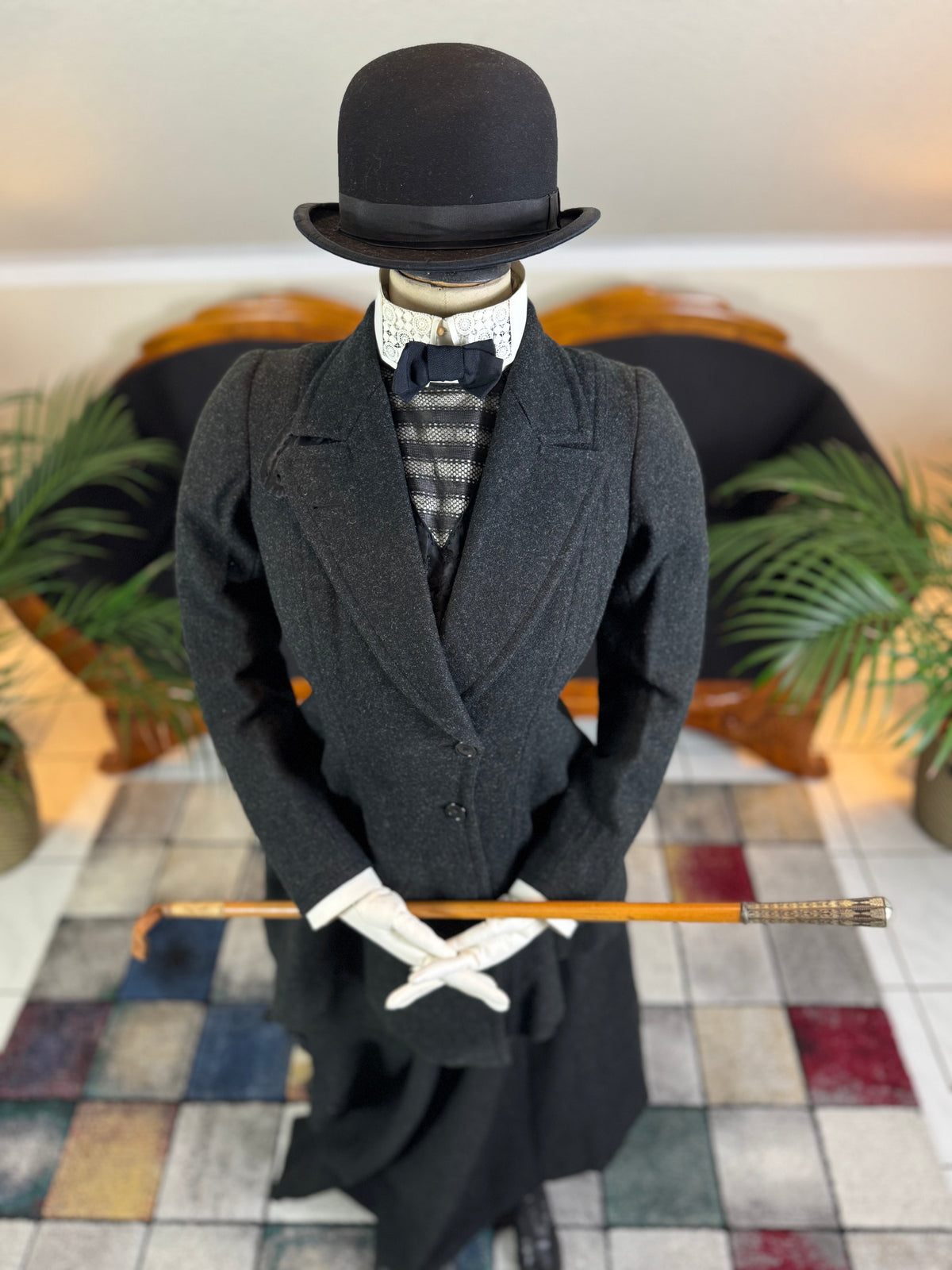 Early 20th‑century British riding ensemble with black wool jacket, skirt and antique accessories