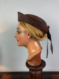 Small French brown straw hat with two back ribbons, sailor‑style shape, well preserved