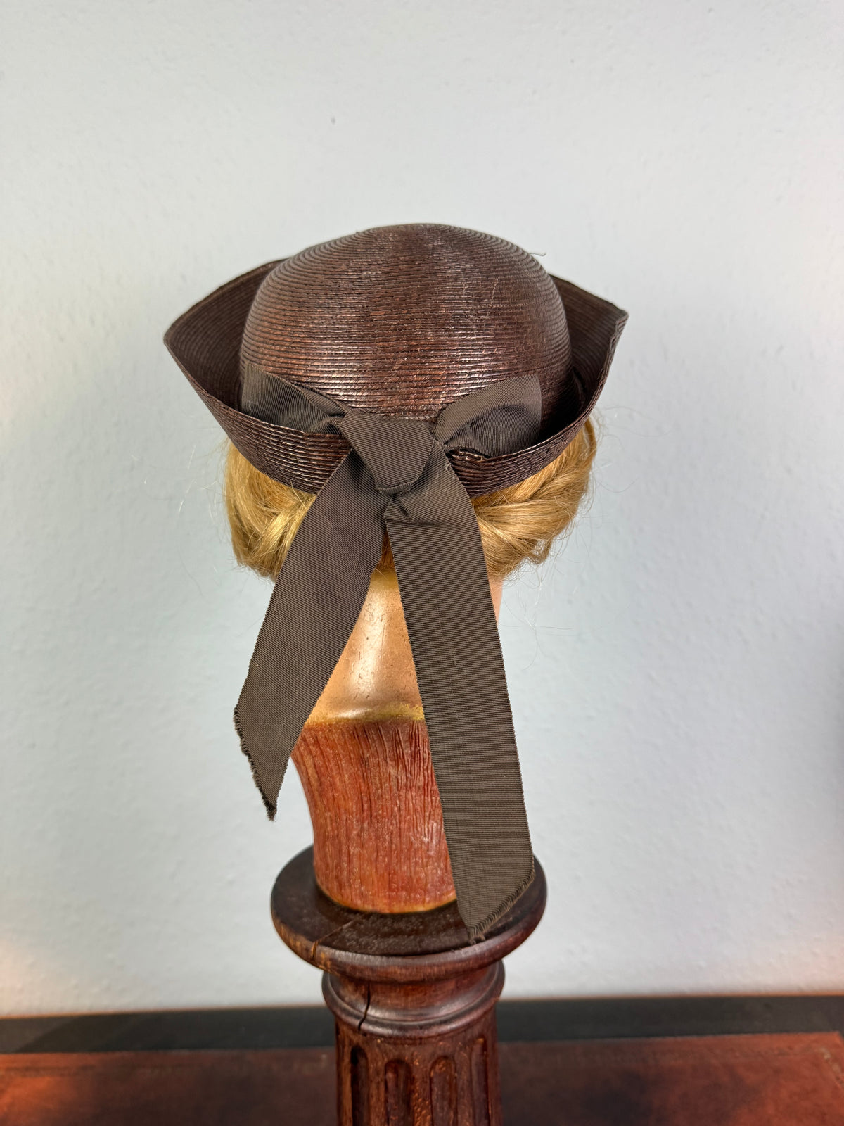 Small French brown straw hat with two back ribbons, sailor‑style shape, well preserved