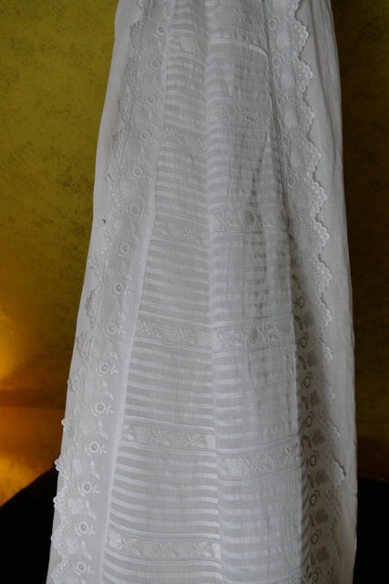 Early 20th‑century christening gown with tie closure and fine embroidery