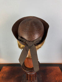 Small French brown straw hat with two back ribbons, sailor‑style shape, well preserved