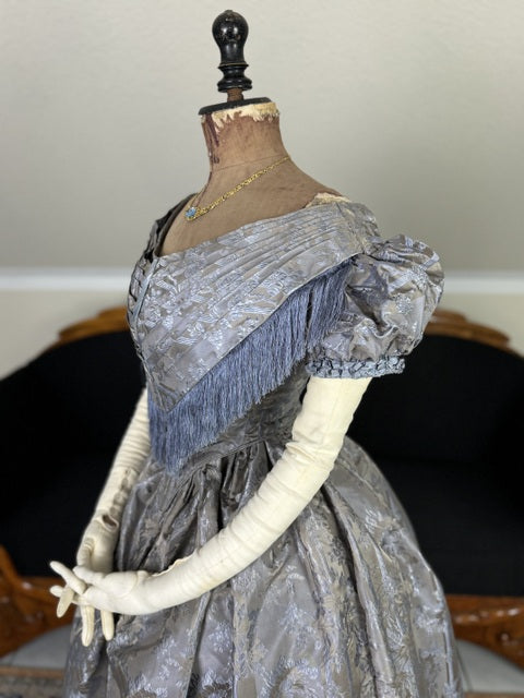 1845 Austrian Biedermeier evening dress in ivory silk with puffed sleeves and fitted bodice, antique gown
